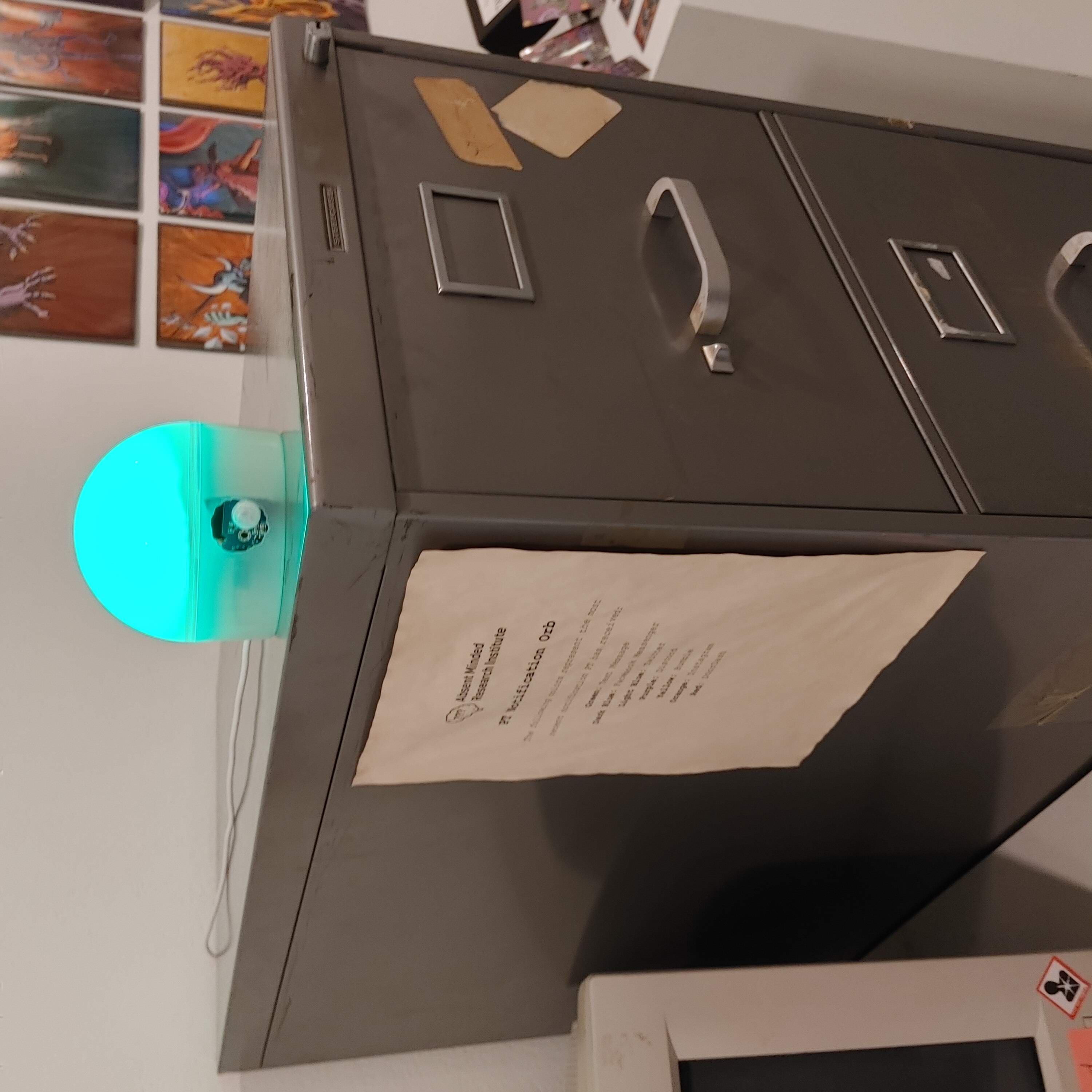 Photo of the notification orb sitting on top of a filing cabinet.