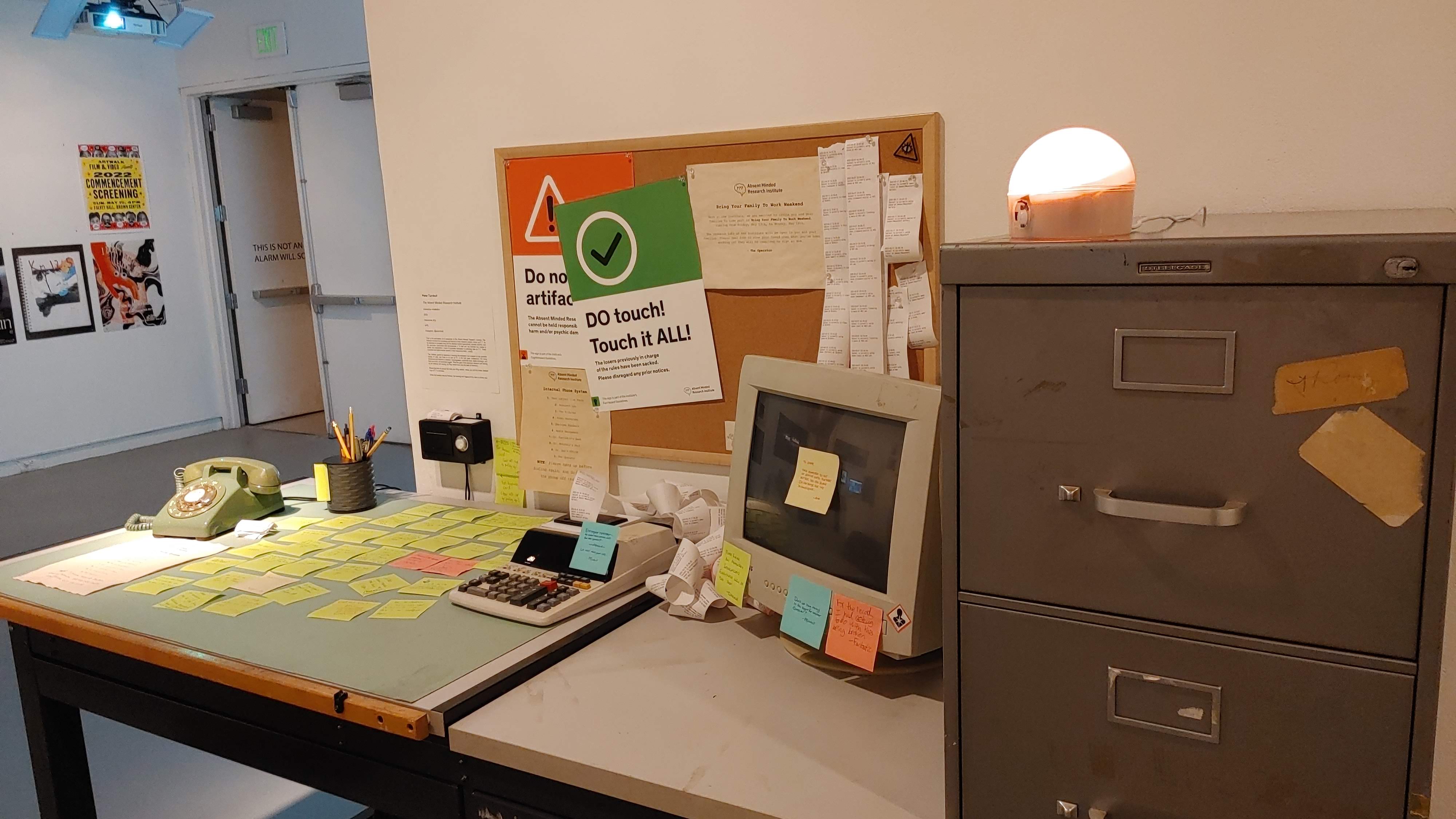 Photograph of thesis project on display. No people are present, just the desk is visible.